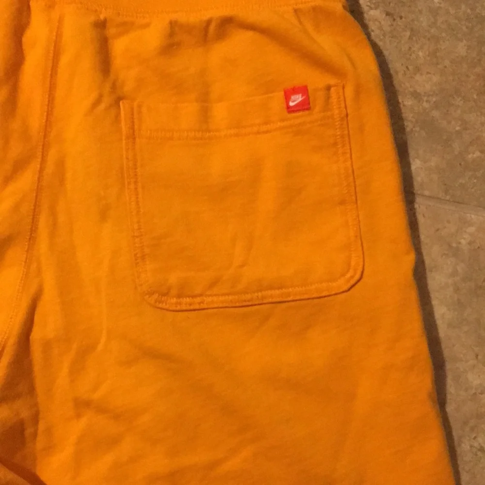 Nike Orange Men's Athletic Shorts with White Logo